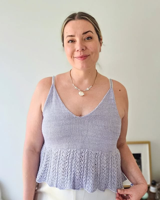 MIDSUMMER COUNTDOWN 3: CLOUD DANCER CAMISOLE ☁️🪻What I love the most about summer knitting are the playful, feminine, flowy textures and fits. Winter knits are often cozy, oversized and quite boxy. Therefore in the summer I crave lightness, colors and different silhouettes. I first experimented with a peplum hem last year in the Summer Knits book with the Juturna camisole, which turned out to be my favorite design to wear from the book. Peplum hems are still trending which inspired me to design another peplum for this summer, but this time with lace detailing. While the lace looks intricate, it is surprisingly easy to knit (also, it only repeats every 4 rows for the whole hem!).The Cloud Dancer Camisole pattern is available on Ravelry and at sarinordlund.com with a 25 % off until tomorrow (end of the day Helsinki time) - no code needed! ✨What was your favorite knit to wear last summer? 🌤️#CloudDancerCamisole by @sari_n_
